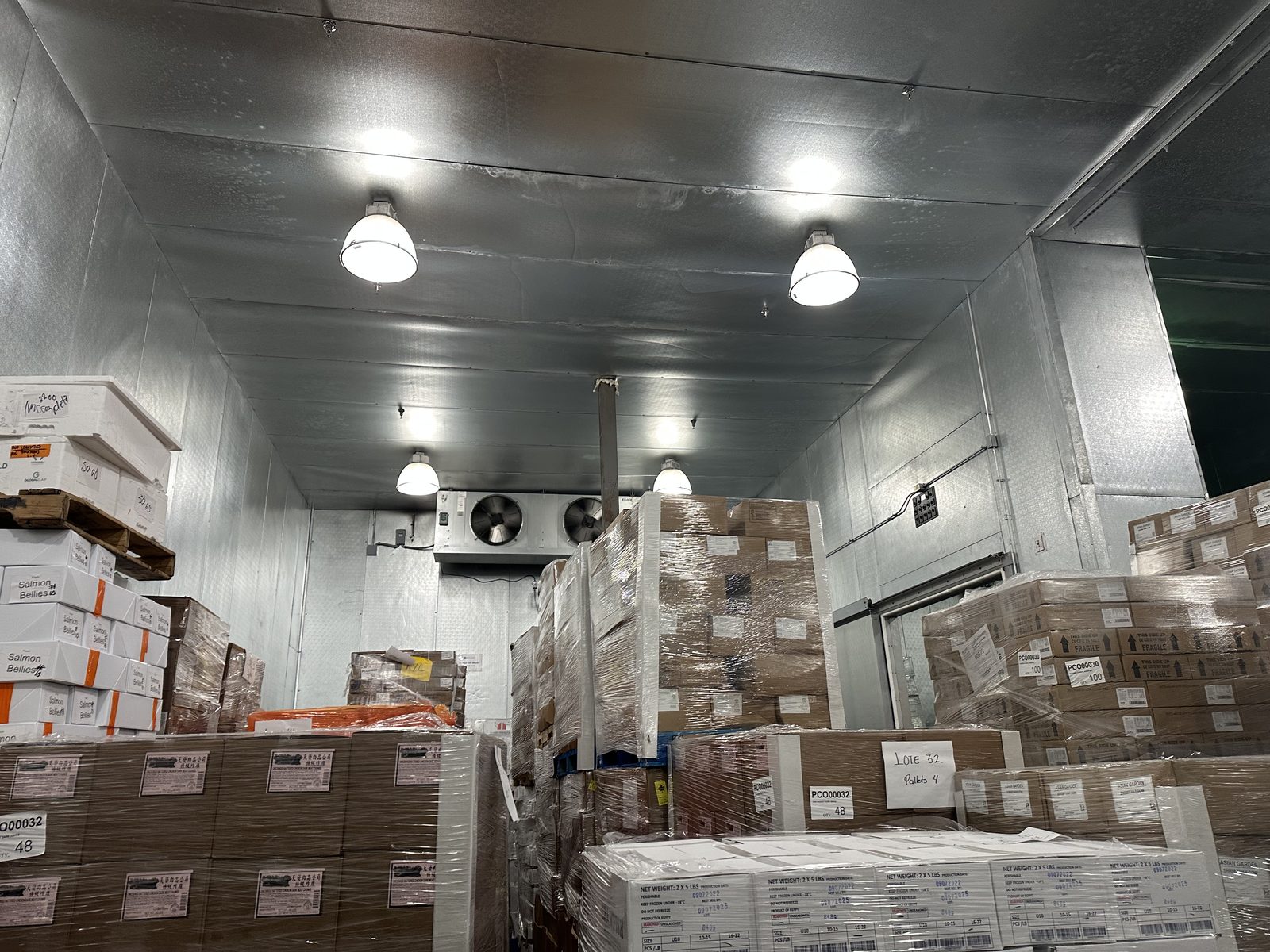 Before installation, floor-stacked pallets leaving most of the freezer's vertical height unused